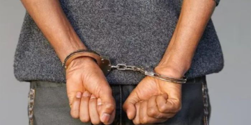 A Suspect Arrested And Put In Handcuffs. Photo/Nation.
