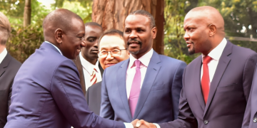 Former CS Moses Kuria (right) shares a light moment with President William Ruto at a past function.