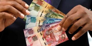 A Photo Of Someone Holding Kenyan Bank Notes.