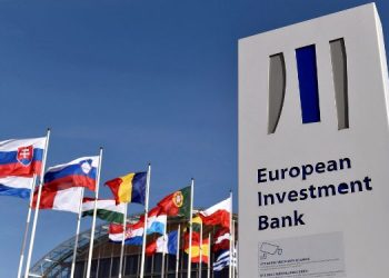 Flags Are Seen Behind The Logo Of The European Investment Bank Pictured In The City Of Luxembourg.