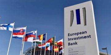 Flags Are Seen Behind The Logo Of The European Investment Bank Pictured In The City Of Luxembourg.