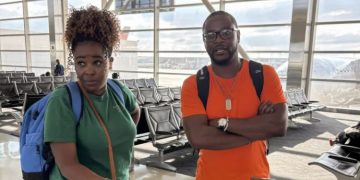 Samuel Kangethe And His Sister Elizabeth Wait To Board Their Flight.