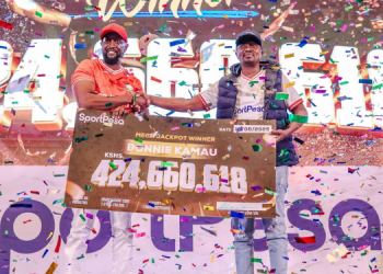 Sportpesa Ceo Ronald Karauri (Left) Hands Over A Cheque To Mega Jackpot Winner Bonnie Kamau On August 13, 2025.