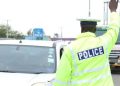 Traffic Police Officer Stops Motorists On Highway.