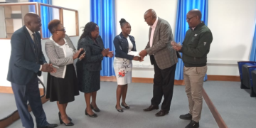 Mku Founder, Prof. Simon Gicharu, Awards Hamia Adhiambo Ouma. Photo/Mku.