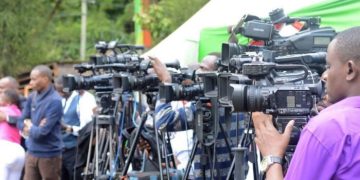 A Group Of Journalists At A Past Press Briefing.