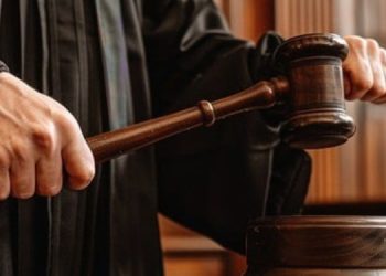 A Judge Holding A Gavel In Court.