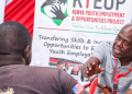 A Photo Of A Nyota Program Official Talking To A Youth During A Youth Drive.